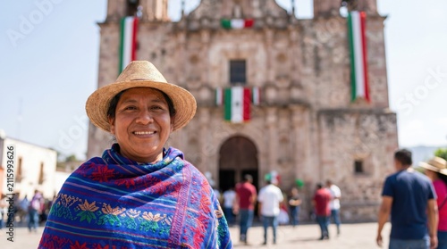 Mature indigenous matriarch wearing traditional woven poncho and straw hat at cultural festival.