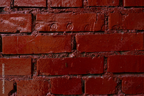 Foto Glossy red painted brick wall with mortar texture and paint drips