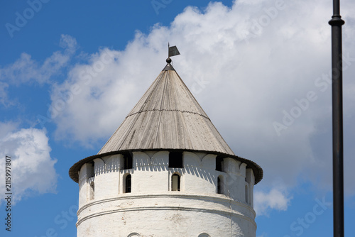 Принти на полотні Round stone tower with wooden shingled roof against blue sky