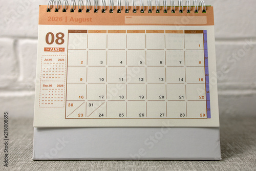 Hello August, desk calendar for planning for August 2026 on the table