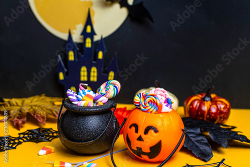 Halloween candy in pumpkin bucket and cauldron