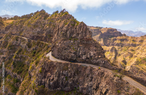 Aerial view of the winding road at Topo da Montanha do Delgadinho, featuring dramatic rocky cliffs and rugged mountain terrain in Corda, Ribeira Grande, Cabo Verde.