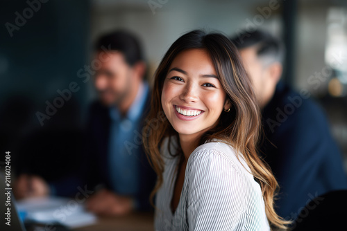 Portrait of happy smiling confident young very attractive businesswoman CEO professional manager entrepreneur in a skirt in a business meeting teamwork looking at camera, diverse businesspeople