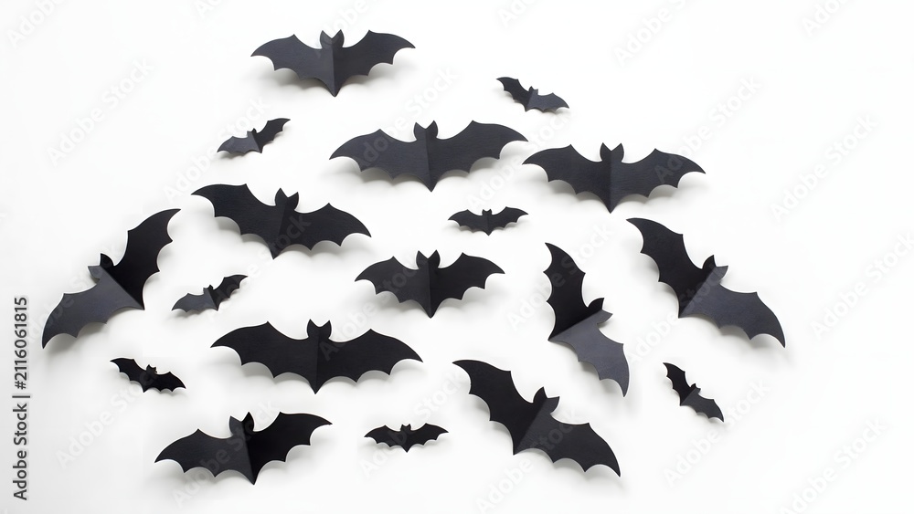 Fototapeta premium Black paper bats for Halloween decoration. Flying bat silhouettes for spooky party decor.