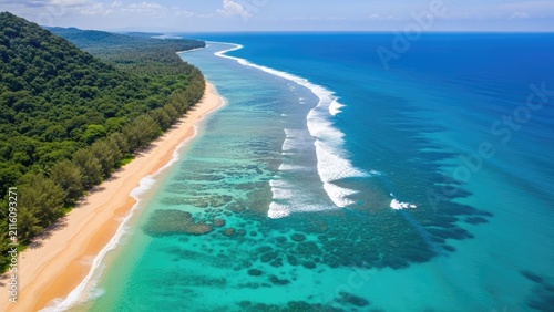Aerial view of tropical beach coastline and turquoise ocean waves.