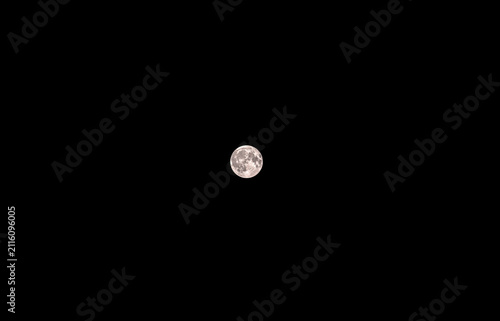Принти на полотні Bright full moon glows in the deep black night sky as the lunar surface reflects