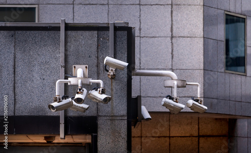 Photography Multiple CCTV security cameras monitoring city building for public safety, surveillance technology and smart urban security system