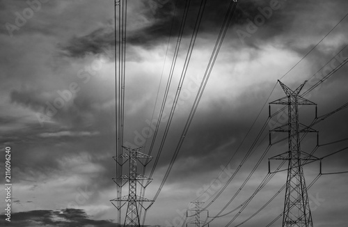 фотографія High voltage electricity transmission towers beneath dramatic storm clouds