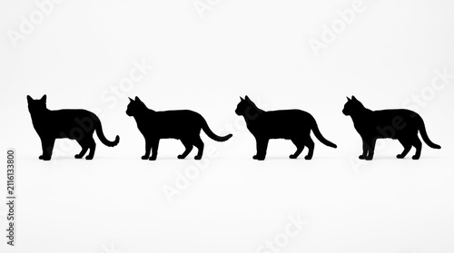 Four black cat silhouettes walking in a line isolated collection of animal shapes for creative design projects and graphic art illustrations showing feline pet movement and posture