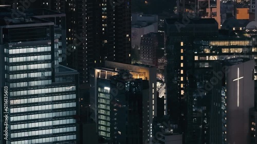July 24 2026 Illuminated office skyscraper glowing in Causeway Bay night.