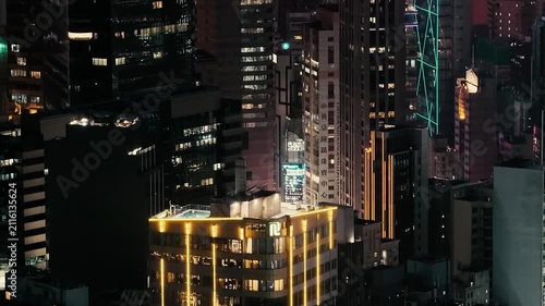 July 24 2026 Illuminated office skyscraper glowing in Causeway Bay night.