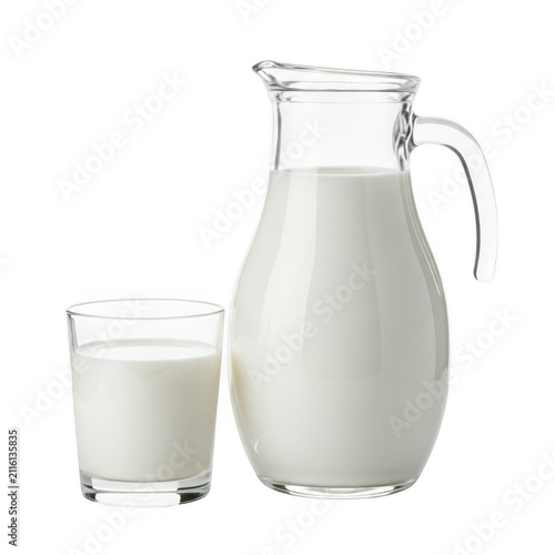 A large pitcher and a glass filled with fresh white milk on a white background