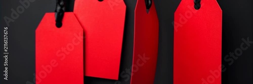 Blank red price tags hanging against a black background, sale, retail website banner with copy space for text