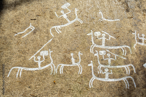 Ancient rock carvings depicting people and ships in Tegneby