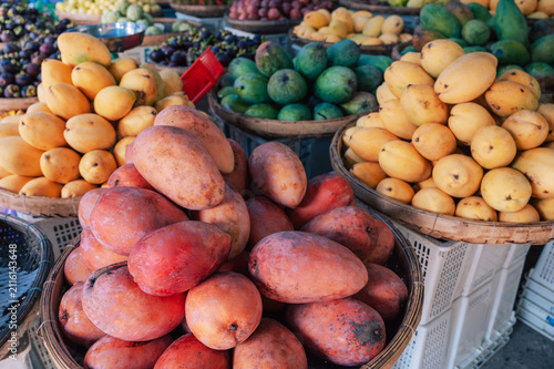 Colorful tropical fruit market featuring piles of ripe mangoes, showcasing fresh produce, local food culture, and vibrant natural colors.