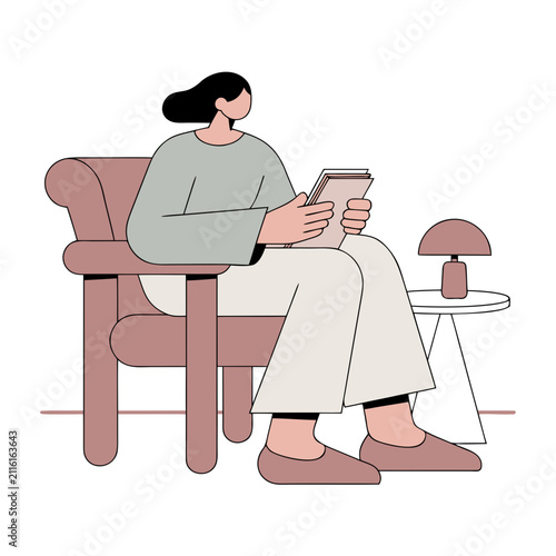 Woman sitting in armchair reading a book with lamp on table  