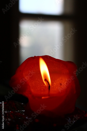 A burning candle in the form of a figurine.