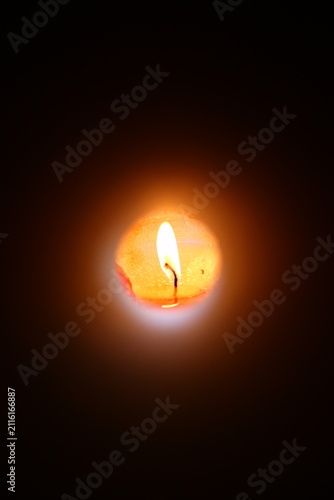 A lighted candle at the end of the pipe.