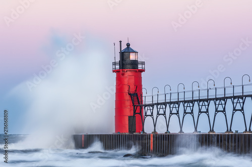 Landscape of the South Haven, Michigan Lighthouse at dawn with splashing waves, Lake Michigan, USA