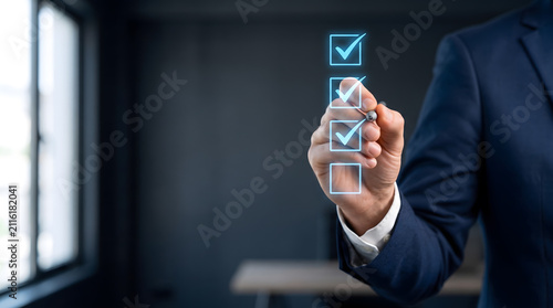 Businessman checking off tasks on virtual glowing checklist. Digital task management and survey concept, Business goals and to do list.