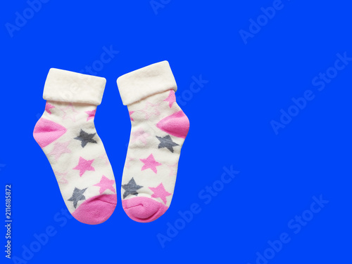 A pair of soft children's socks with a vibrant print. Cozy and warm knitted apparel for toddlers, isolated close-up shot. Concept of comfort, care, and kids' fashion.