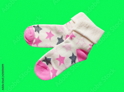 A pair of soft children's socks with a vibrant print. Cozy and warm knitted apparel for toddlers, isolated close-up shot. Concept of comfort, care, and kids' fashion.