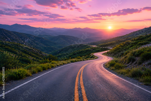 Serpentine mountain road winds through lush highland valley beneath pastel pink sunset creating tranquil scenic journey inspiring travel freedom adventure and discovery outdoors