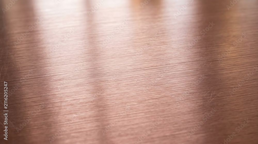 Fototapeta premium Abstract background featuring a smooth rose gold metallic texture with soft light reflections and elegant gradients