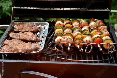 Grilled vegetable skewers and pork steaks