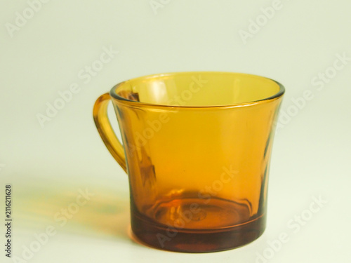 amber brown mug with handle isolated on plain clean background