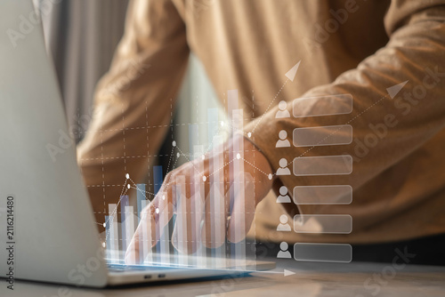 Business professional analyzing customer data and financial growth charts on laptop dashboard. Digital marketing analytics, business performance, CRM strategy, and data visualization concept.