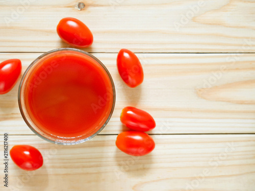 Photography A glass of tomato juice on wooden table