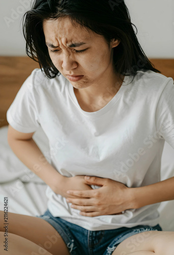 Young asian woman suffering...
