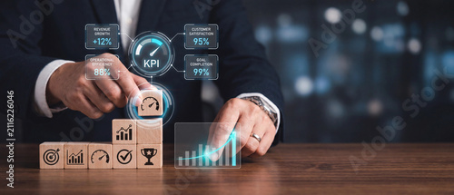 Businessman building a business growth stack with wooden blocks and digital kpi performance dashboard interface