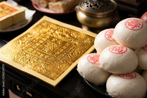 Golden joss paper with auspicious buns in a traditional ritual setting