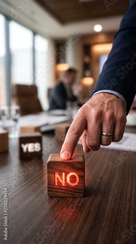 Corporate businessman hand pointing at a wooden block displaying a red glowing no word deciding against an option on a modern office conference table.