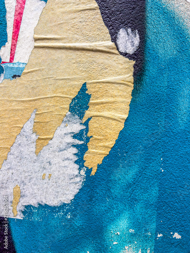 Layers of old colorful posters on wall damaged by time for your grunge style design