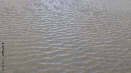 Beautiful abstract sand art peaceful background from the changing of the tide of the ocean at the beach