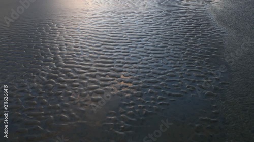 Beautiful abstract sand art peaceful background from the changing of the tide of the ocean at the beach