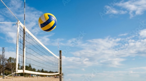 A vibrant yellow and blue volleyball caught mid-flight above a white net on a sunny sandy beach, under a clear blue sky, perfect for summer sports and outdoor recreation