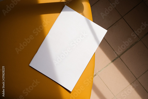 empty magazine mockup on soft chair indoors