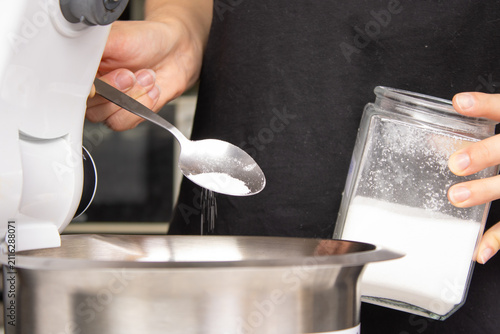 Картината върху платно Adding Sugar to Mixing Bowl for Cake Batter