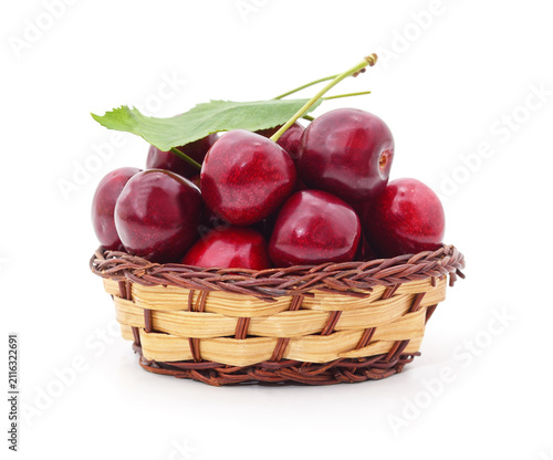 Fresh red cherries in a basket on white background.