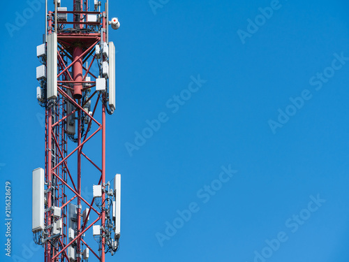 Mobile Telecommunications Tower for 5G Wireless Network Against Bright Blue Sky