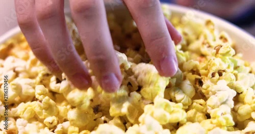 eating cheese-flavored popcorn before watching a movie. Movie buffs.