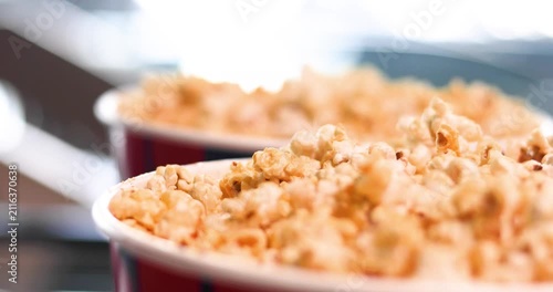 handling and eating popcorn before watching a movie. Movie buffs