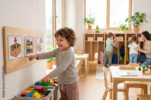 Child Using Classroom Visual Routine Board for Independent Learning