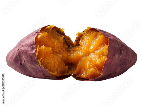 Warm baked sweet potato broken open showing juicy bright orange interior
