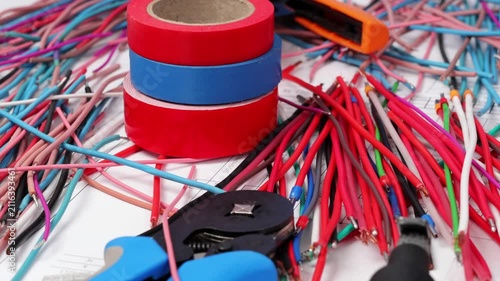 Tools and materials for assembling an electrical switchboard in the workplace.