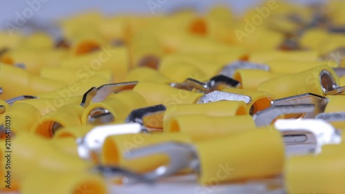 Metal tips with a plastic base for mounting on stranded copper wires. Close-up. Soft focus. Macro.
